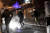 그리스 경찰들이 건물 옥상에서 시위대가 던진 화염탄을 지나가고 있다. [AFP=연합뉴스]