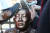 신군부가 일으킨 12·12 군사반란 40주년인 12일 5.18 관련 단체 회원들이 서울 광화문광장에서 전두환 전 대통령의 구속 수사를 촉구하는 기자회견을 한 뒤 이를 상징적으로 표현하기 위해 제작한 동상 조형물을 때리는 퍼포먼스를 하고 있다. [연합뉴스]