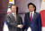 문재인 대통령이 24일 오후 중국 쓰촨성 청두에서 아베 신조 일본 총리를 만나 악수하고 있다. [청와대사진기자단]