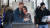 지난 10일 해리 왕손과 메건 마클 왕손비가 왕실으로부터의 독립을 선언 한 뒤 영국 시민들이 윈저지역에 위치한 해리 왕손 부부의 사진 앞을 무심하게 지나가고 있다. [AP=연합뉴스]