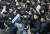 더불어민주당 이해찬 대표가 23일 오전 서울 용산역에서 귀성객들에게 설 인사를 한뒤 장애인 단체의 사과 요구를 받으며 승강장을 빠져나가고 있다. [연합뉴스]