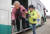 22일 경남 합천군 삼가면 한 마을 앞에서 버스도우미 김영애(50·여)씨가 어르신의 하차를 돕고 있다. 송봉근 기자
