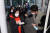 24일 인천국제공항 1터미널에서 입국한 강원대 중국인 유학생들이 학교에서 마련한 버스에 탑승하기 전 손과 몸을 소독하고 있다. [연합뉴스]