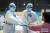 중국 우한의 장샤팡창의원에서 후난중의약대학 제일부속의원의 주잉 부원장(왼쪽)이 신종 코로나 환자의 맥박을 재고 있다. [중국 신화망 캡처]