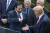 13일 백악관 기자회견장에서 악수를 청하는 트럼프 대통령에게 그린스타인 LHC 부사장이 오른손 팔꿈치를 내밀고 있다.뉴시스
