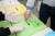 지난 26일 광주광역시 수완동 우산신협 야외 투표장을 찾은 신협 조합원이 비닐장갑 착용한 뒤 투표함에 투표용지를 넣고 있다. 프리랜서 장정필