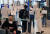지난달 30일 인천국제공항에서 관계자들이 코로나19 무증상 입국자들을 전용 공항버스로 안내하고 있다.뉴스1