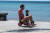 26일 스페인 란사로테 섬의 한 해변에서 아빠와 아이가 자전거를 타고 있다. EPA=연합뉴스