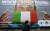 이탈리아 나폴리 거리에서 이탈리아 국기를 신종 코로나바이러스 감염증(코로나19) 예방 마스크로 표현한 대형 포스터 앞으로 한 남성이 지나고 있다. [AFP=연합뉴스]