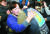故 김용균 씨 어머니인 김미숙씨(왼쪽)가 2018년 12월 국회에서 '김용균법'으로 불리는 산업안전보건법 개정안에 대한 여야3당 합의 소식을 듣고 故 김용균 씨 직장동료와 포옹하고 있다. [뉴스1]