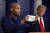 트럼프 대통령이 4월 22일 브리핑에서 외과의사인 제롬 애덤스가 코로나19 방역 마스크를 소개하는 모습을 지켜보고 있다. [AP=연합뉴스]