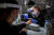 포르투갈 리스본의 한 뷰티살롱에서 미용사와 손님 모두 마스크실드와 마스크를 착용하고 손톱을 손질하고 있다. [AFP=연합뉴스]