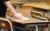 20일 오전 광주 남구 봉선동 동아여자고등학교 3학년 교실에서 학생이 책상과 의자를 소독하고 있다. 뉴시스