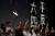 지난해 6월 4일 밤 홍콩 빅토리아 공원에서 열린 천안문 사태 추모 촛불집회에서 홍콩 시민들이 ‘6.4 사태를 재평가하라’는 구호가 적힌 플래카드 앞에서 촛불을 들어올리고 있다. [로이터=연합뉴스]
