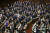 지난 3월 12일 열린 일본 중의원 본회의에 참석한 의원들이 기립하고 있다. [AP=연합뉴스]