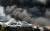 19일 전북 전주시의 한 자동차 폐차장에서 화재가 발생해 소방관들이 화재를 진압하고 있다. 뉴시스