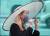 26일 오후 서울 강남역에서 열린 K거리두기운동본부 모델이 전통 선비갓에서 영감을 얻어 만든 거리두기 모자(K-god)를 착용하고 캠페인을 벌이고 있다. [연합뉴스]