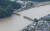  일본 구마모토현에 내린 폭우로 구마강이 범람하면서 다리가 유실됐다. [AFP=연합뉴스]