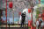지난 2월 디즈니 실사영화 '뮬란'의 홍보물 근처에 서 있는 중국인 남성. 코로나19 사태로 인해 수차례 개봉이 연기돼온 '뮬란'이 오는 11일 중국에서 개봉한다. [AP=연합뉴스]