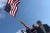 도널드 트럼프 미국 대통령 지지자가 18일 미국 뉴욕에서 트럼프 대통령 등신대 뒤에서 성조기를 흔들고 있다. [로이터=연합뉴스]