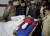 13일 파키스탄 카슈미르 지역에서 주민들이 부상을 입은 아이 곁에 모여 있다. AP통신=연합뉴스