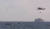 0일 오전 충남 태안해양경찰서 경찰관들이 헬기를 이용해 태안 앞바다에서 조업 중 전복된 선원을 구조하고 있다. 연합뉴스