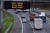 지난달 20일 영국 스코틀랜드 글래스고의 고속도로에서 코로나19 예방을 위해 장거리 이동이나 외출을 자제하라는 안내문이 표시되고 있다. AFP=연합뉴스