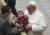 21일(현지시간) 프란치스코 교황이 크리스마스를 앞두고 열린 특별알현에서 교황청 직원의 아이를 안고 있다. EPA=연합뉴스