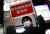지난 8일 일본 도쿄지하철 직원이 '긴급사태 선언 발령중'이란 안내판을 들고 시민들에게 이른 귀가를 호소하고 있다. [로이터=연합뉴스]