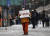 눈이 내린 18일 오전 서울역에 마련된 임시선별검사소 인근에서 한 자원봉사자가 거리두기 실천을 촉구하고 있다. 연합뉴스