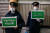 지난 22일 일본 도쿄에서 경찰들이 시민들에게 외출 자제를 호소하는 내용의 안내판을 들고 있다. [AFP=연합뉴스]