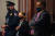 지난달 6일 미국 워싱턴 의사당 폭동 당시 홀로 시위대에 맞섰던 의회 경찰 유진 굿맨(오른쪽)이 10일 상원에서 열린 트럼프 전 대통령 탄핵심판에서 상영되고 있는 증거 영상을 보고 있다. [로이터=연합뉴스]