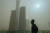 28일(현지시간 ) 중국 베이징에서 마스크를 쓴 남성이 중앙상업지구가 보이는 전망대 앞을 걸어가고 있다. 이날 중국 중앙기상대는 베이징과 허베이 등 15개 성에 황사 황색경보를 발령했다. 베이징 일대의 미세먼지(PM10) 농도 역시 2500㎍/㎥으로 심각한 수준을 기록했다. [EPA=연합뉴스]