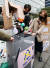 지난달 서울 광화문에서 열린 행사에서 참석자들이 재활용이 어려운 화장품 용기를 박스에 담는 모습을 연출하고 있다. [연합뉴스]