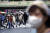 코로나19 확산으로 세번째 긴급사태가 선언된 일본 도쿄에서 지난달 29일 마스크를 쓴 시민들이 시부야역 앞을 지나고 있다. [AP=연합뉴스]