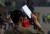 6일 오전 서울 중구 서울역 광장 임시선별검사소에서 한 시민이 신종 코로나바이러스 감염증(코로나19) 검사를 받기 위해 대기하던 중 종이로 햇볕을 가리고 있다. 뉴스1