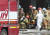 지난 17일 오후 화재가 발생한 경기도 이천시 마장면 쿠팡 덕평물류센터에서 소방 관계자들이 탈진한 소방관을 병원으로 이송하고 있다. 연합뉴스