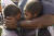 브로디 맥시(7)와 브래덴(9) 형제가 19일 아버지와 함께 텍사스주 갤버스톤에서 열린 준틴스 축하 행사에 참석해 아프리카 정교 교회에서 기도하고 있다. AFP=연합뉴스