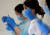 지난 12일 일본 고베시의 코로나 백신 접종회장에서 의료진이 접종 준비를 하고 있다. [로이터=연합뉴스]