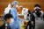 21일 광주 북구보건소 의료진들이 북구 한 초등학교에 설치된 이동선별진료소에서 학생들을 대상으로 신종 코로나바이러스 감염증(코로나19) 전수조사를 실시하고 있다. 뉴스1