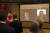 11일 베이징 캐나다 대사관에서 이날 간첩죄로 11년 형을 판결받은 캐나다 국적의 마이클 스페이버(오른쪽)와 마이클 코프릭(왼쪽)의 영상을 비추고 있다. [AP=연합뉴스]