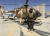 5일(현지시간) 한 탈레반 병사가 노획한 헬기와 전투기 등이 있는 아프가니스탄 카불 공항에서 경계를 서고 있다. [AP=연합뉴스]