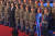 김정은 북한 국무위원장이 11일 국방발전전람회 개막식에서 에어쇼를 펼친 파일럿들과 기념 사진을 촬영하고 있다. 앞줄 오른쪽에서 두번째로 서 있는 인물은 파란색의 독특한 차림이다. [조선중앙통신=연합뉴스]