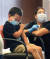 3일(현지시간) 미 텍사스주 에딘버그의 에딘버그 컨퍼런스 센터에서 한 8세 어린이가 화이자 백신을 접종하면서 고개를 돌리고 있다. [AP=뉴시스]