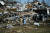 12일(현지시간) 켄터키 메이필드시의 완전히 파괴된 집 앞에서 주민들이 서로를 끌어안고 있다.[AFP=연합뉴스]