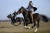 루마니아의 피에트로사니 마을에서 6일(현지시간) 청년들이 말을 타고 경주를 하며 주현절을 즐기고 있다. [AP=연합뉴스]