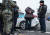 카자흐스탄 군과 경찰 순찰대가 10일 알마티 거리에서 한 남성을 체포하고 있다. TASS=연합뉴스