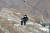  김정은 북한 국무위원장(당시 국방위 제1위원장)이 2013년 12월 완공된 마식령스키장의 리프트를 타고 슬로프를 오르는 모습. [조선중앙통신=연합뉴스]