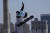 14일 오전 중국 베이징에서 열린 2022 동계 올림픽 스노보드 여자 빅에어 예선에서 스위스의 아리안 뷰리 선수가 하늘과 굴뚝을 배경으로 연기를 펼치고 있다. AP=연합뉴스