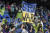 미국 메이저리그 축구(MLS) 시애틀 사운더스 팬이 내쉬빌과 홈 경기 당일 전쟁을 반대하는 배너를 들어 보이고 있다. [AP=연합뉴스]